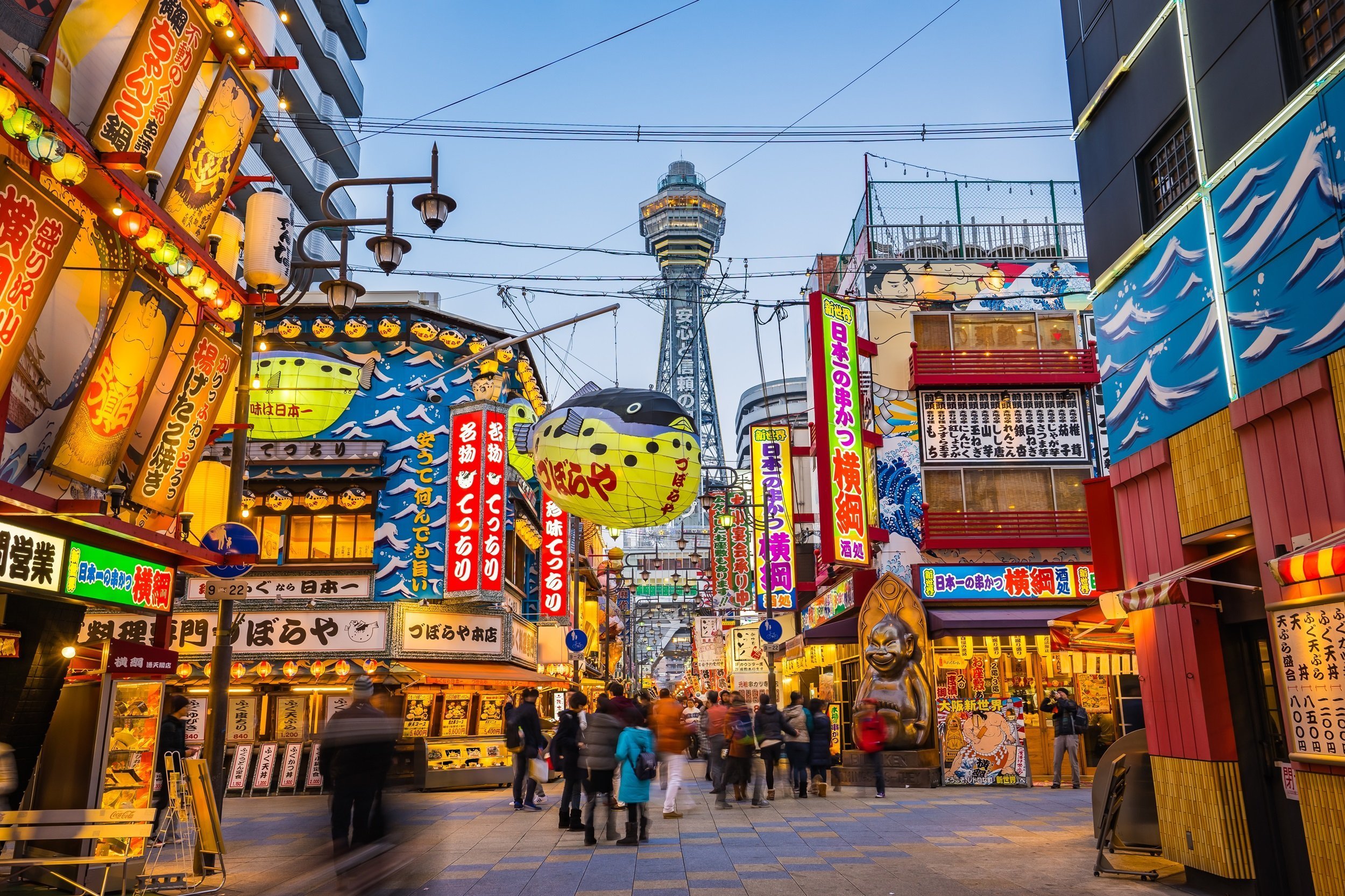 11 Day Budget Japan Tour - Osaka, Japan- January 4, 2016: Tsutenkaku Is A Tower And Well-known Landmark Of Osaka, Japan And Advertises Hitachi. It Is Located In The Shinsekai District Of Naniwa-ku, Osaka.